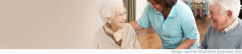 An older couple with a carer